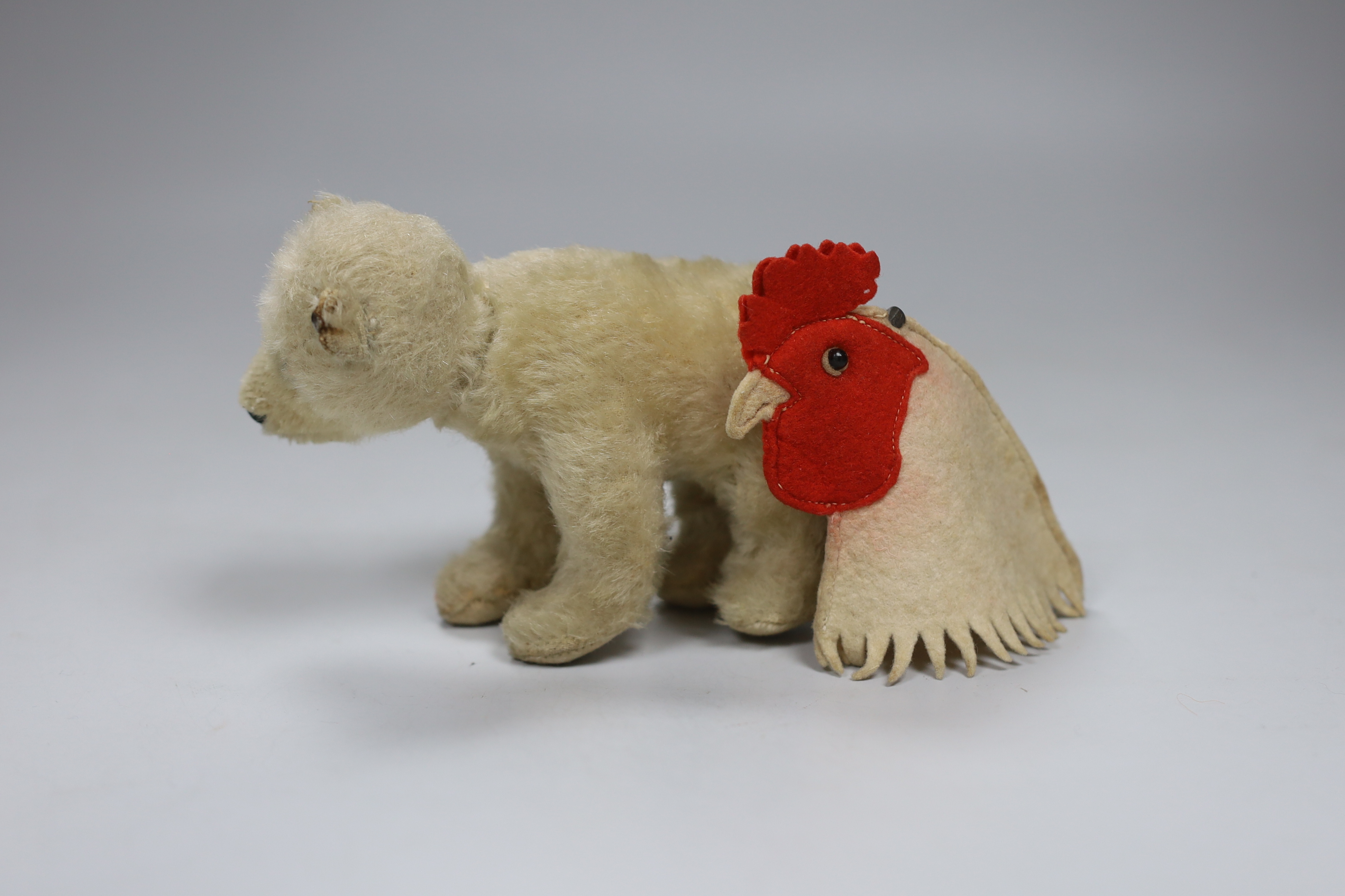 A Steiff hen egg cosy, c.1910, with button, 3in., and a 1950's Polar bear, button, good condition